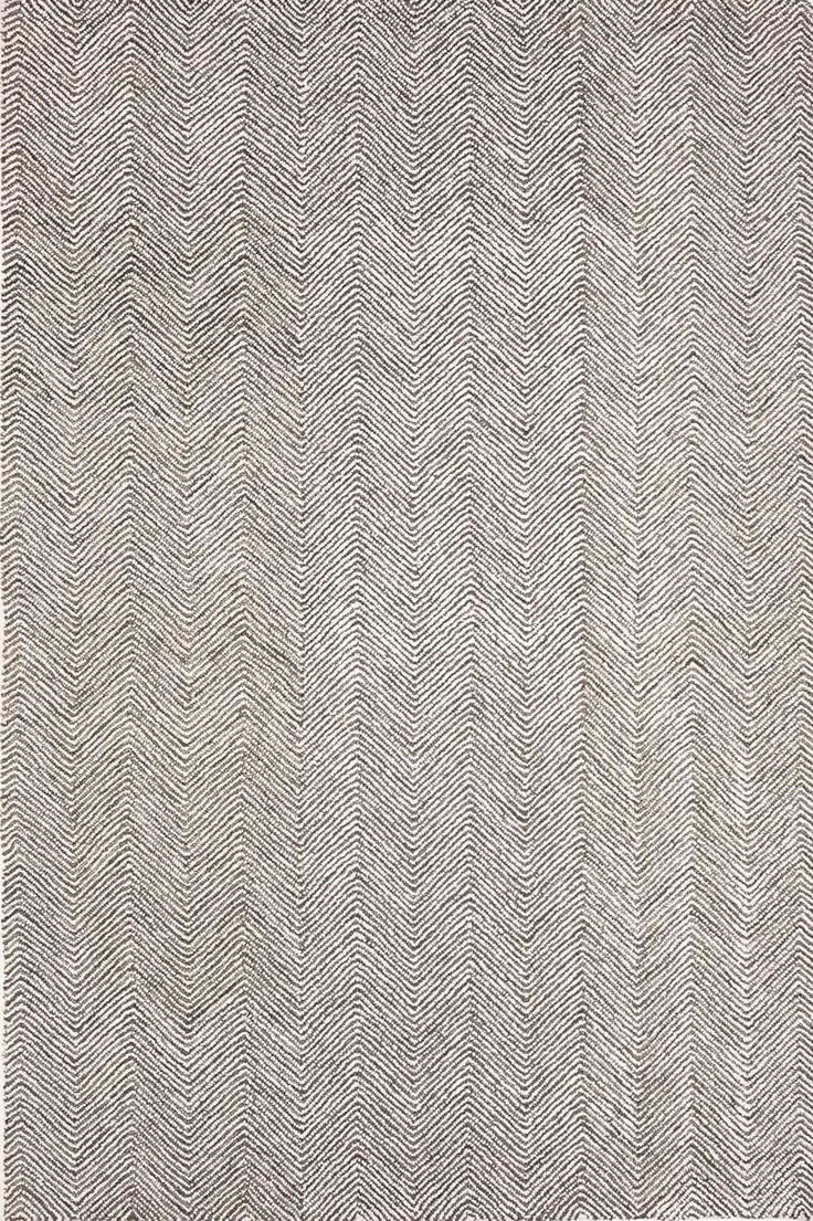 an area rug with white and gray herringbones