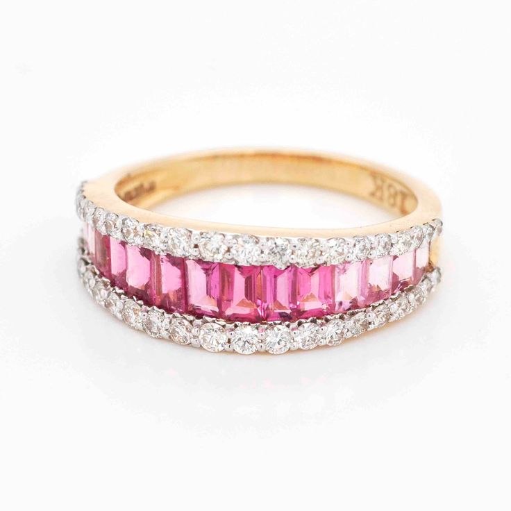 Step into a world of timeless beauty and sophisticated allure with our exquisite 18-karat gold Pink Tourmaline Baguette Diamond Contemporary Wedding Band Ring. This enchanting piece is a true masterpiece, expertly designed to capture the essence of art, color, and culture in a seamless blend of elegance and contemporary charm. Elegant Yellow Gold Ruby Ring With Baguette Diamonds, Elegant Ruby Ring With Baguette Diamonds In Yellow Gold, Luxury Ruby Ring With Baguette Cut, Luxury Ruby Baguette Cut Ring, Luxury Ruby Ring With Baguette Diamonds, Elegant Pink Ruby Half Eternity Ring, Elegant Ruby Ring With Baguette Diamonds, Wedding Rings With Baguette Cut Tourmaline, Baguette Cut Tourmaline Wedding Ring