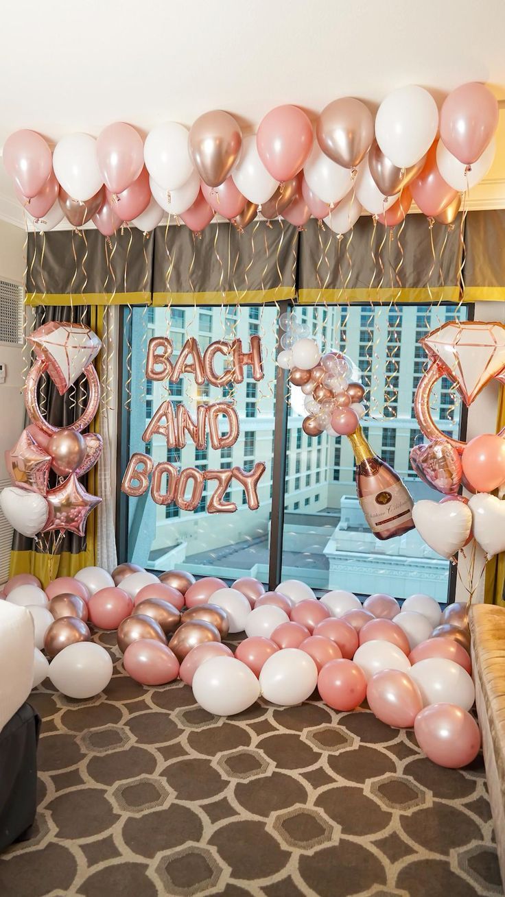 a room filled with balloons and streamers in front of a window that says bachelor and groozy