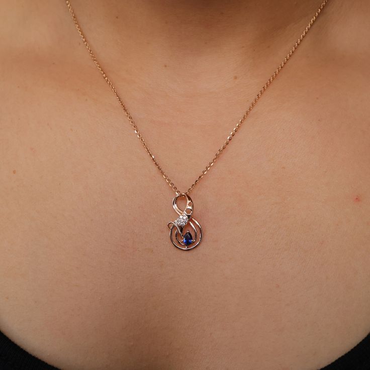 PEAR BLUE INFINITY PENDANT WITH CHAIN Stone Details → Shape:Round → Size: 1.10 ↣ Weight: 0.007 → Make: High Quality  ↣ Type: Moissanite ↣ Color: Colorless → Shape:Pear → Size: 3x4 ↣ Weight: 0.21 → Make: High Quality  ↣ Type: Moissanite ↣ Color: Blue Handmade item Materials: Gold, Rose gold, White gold Chain style: Cable Style: Minimalist Jewelry style: Art deco Necklace length: Adjustable length Can be personalized Made to Order This jewelry set is available in silver, gold or pink gold(rose gold) color to match your dress Making Process: Handmade - Crafted by our experienced team The material used in these Necklace and earrings set are free from Lead, Nickel, Cadmium so it will not give you any skin irritation and environment friendly too.. MEASUREMENTS :- Necklace measurement can be cust Elegant Blue Necklaces For Mother's Day, Blue Elegant Necklace For Mother's Day, Blue Necklace For Mother's Day, Blue Round Necklace For Mother's Day, Diamond And Sapphire Necklace, White Gold Chain, Infinity Pendant, White Gold Chains, Art Deco Necklace