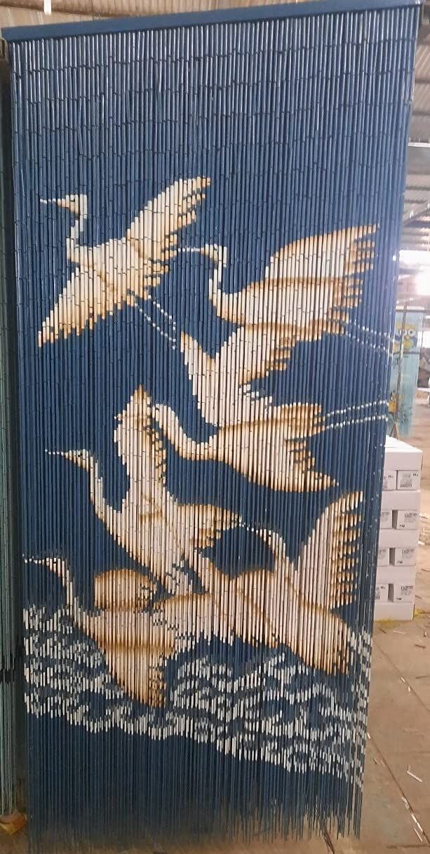 an artistic painting on the side of a building in china, depicting two birds flying