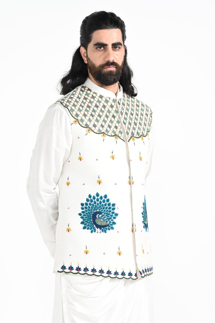 A dewy mist coloured Rajasthani inspired peacock motif hand embroidered nehru jacket with a cowl draped kurta made of bamberg raw silk. Paired with white slim fit Pant Pajama. Color of the actual garment may vary due to lighting conditions during the shoot.

Size Chart For Men





	
	
					Men's Size Chart
		

		
		
						
				Size Chart For Men
				Custom Size Measurement Guide
			
			
				
				
				Custom Size Measurement Guide
1. Take your measurements at ease…don’t hold your breath!
2. Be a Cotton Silk Bandhgala With Resham Embroidery For Spring, Spring Cotton Silk Bandhgala With Resham Embroidery, Traditional Cotton Silk Nehru Jacket With Cutdana, Traditional Nehru Jacket In Cotton Silk With Cutdana, Traditional Nehru Jacket With Cutdana In Cotton Silk, Designer Nehru Jacket With Chikankari Embroidery, Embroidered Cotton Silk Nehru Jacket For Eid, White Embroidered Cotton Silk Bandhgala, Embroidered White Cotton Silk Bandhgala