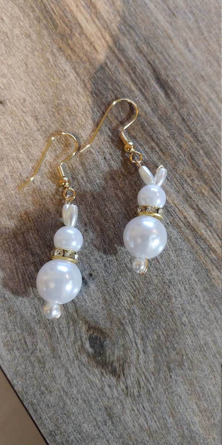 Order by MONDAY, March 26th, 2021 to guarantee delivery before Easter (without rush shipping charges). Adorable freshwater pearl bunny earrings shout Easter.  Just in time for Easter these adorable bunny earrings come in several varieties, just specify which you want in your order.  Adorable for yourself or a GREAT gift idea!  Perfect for adults or girls, you just can't go wrong!     #1 silver collar #2 gold collar #3 no collar  all styles come with your choice of: (enter selection under personalization) gold hypo-allergenic ear hooks silver hypo-allergenic ear hooks plastic no metal ear hooks or gold or silver post w/backs   Earrings: 1-1/2" long with silver plated earring hook wires   These were designed by my grand-daughter and myself as we launch our jewelry making endeavor. We are bui Beaded Dangle Pearl Earrings For Gift, Beaded Dangle Pearl Earrings As Gift, Dangle Beaded Pearl Earrings Gift, Handmade Pearl Beaded Earrings As Gift, Gift Pearl Earrings With Ear Wire, Pearl White Earrings For Gift, Handmade Pearl White Beaded Earrings Gift, Gift Pearl Earrings With Round Beads, White Hypoallergenic Beaded Earrings As Gift