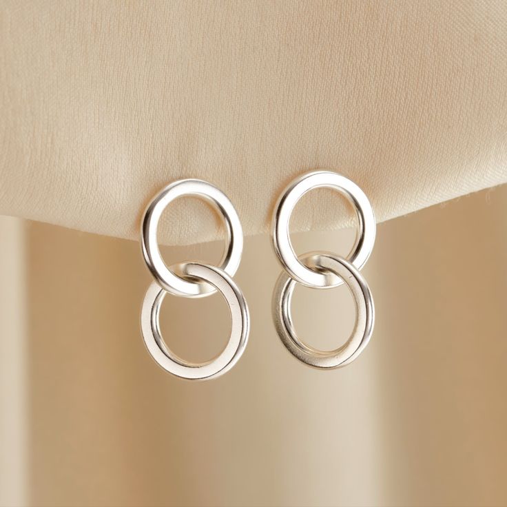 These Sterling Silver Interlinking Hoop Charm Stud Earrings feature an elegant double-ring design, the top ring has an earring post and butterfly fastening at the back while the interlinked lower ring hangs freely and catches the light beautifully. Handmade in 925 Sterling Silver, these earrings a perfect accessory for both casual and more formal outfits. Handmade in Sterling Silver. Please note that due to hygiene reasons, Earrings are non-returnable. Each item is individually handmade to order Stocking Fillers For Her, Hoop Charms, Silver Jewelry Earrings, Forever Jewelry, Formal Outfits, Earring Post, Jewelry Ring Box, Creating Jewelry, Double Ring