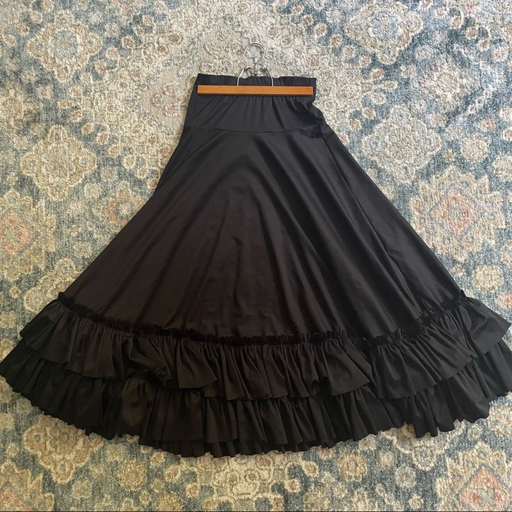 Black Ballroom Practice Skirt With Ruffle At The Bottom Black Ruffled Full Skirt Petticoat, Black Flowy Petticoat For Spring, Spring Black Flowy Petticoat, Spring Black Petticoat, Black Tiered Ruffled Skirt, Elegant Black Full Skirt Petticoat, Fitted Black Long Petticoat, Elegant Black Petticoat For Spring, Spring Black Lined Petticoat