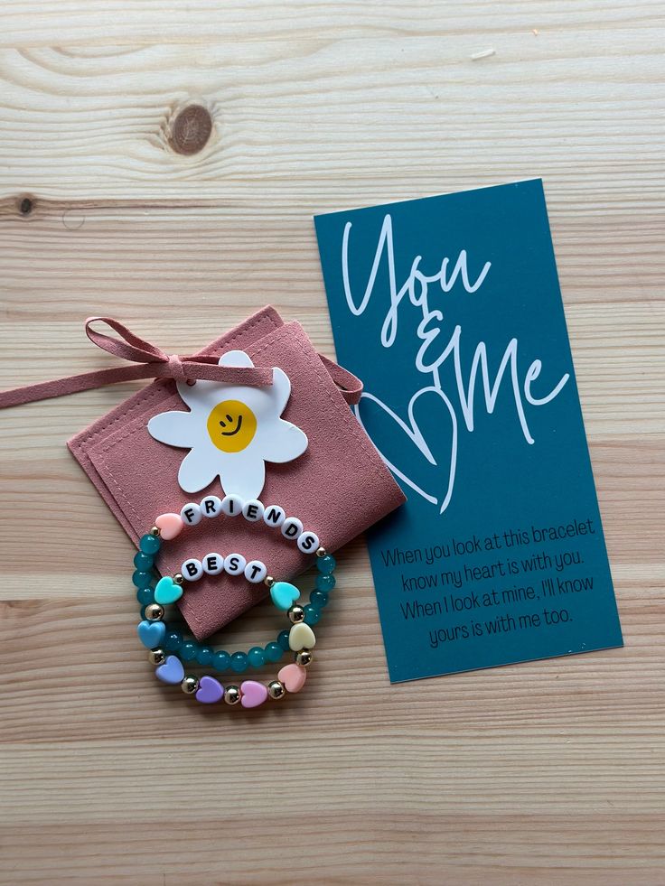 "Staying connected to your little bestie day after day. Whether a mommy, an aunt, or just a good friend - you & me bracelet set it a great reminder that your hearts are tied together!  The bracelets comes with the backing board (as pictured), the suede pouch, and the flower die cut.   The child bracelet will have all the heart colors and the adult bracelet will be whichever bead and heart color selected.  The large bracelet is an adult standard size of 6.75\" and the smaller bracelet is child st Personalized Stretch Bracelet For Gift, Inspirational Personalized Beaded Bracelets For Best Friend, Meaningful Name Bracelet For Friendship On Mother's Day, Name Bracelet For Best Friend And Mother's Day Gift, Meaningful Bracelets For Best Friend And Mother's Day, Adjustable Meaningful Name Bracelet For Best Friend, Meaningful Adjustable Name Bracelet For Best Friend, Inspirational Beaded Bracelets For Valentine's Day Friendship, Handmade Name Bracelet For Mother's Day And Friendship