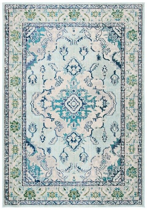 a blue and white rug with an ornate design on the center, in front of a light green background