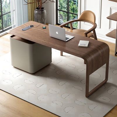 an office desk with a laptop on it in front of a large window and wooden chairs