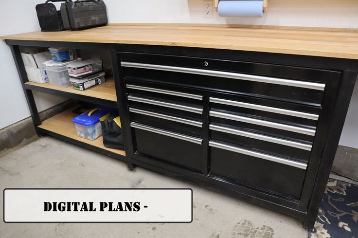 there is a black cabinet with many drawers and tools on the shelf next to it