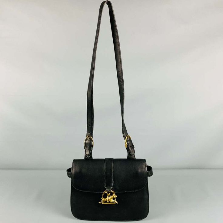 Vintage Ralph Lauren Handbag In Black Leather Featuring A Shoulder Bag Style, Expandable Interior, And Gold Tone Equestrian Closure.Very Good Pre-Owned Condition. Minor Signs Of Wear, Particularly On The Gold Tone Closure. Measurements: Length: 10 Inches Width: 1.25 Inches Height: 7.25 Inches Sui Generis Reference: 128807 Category: Handbag & Leather Goods More Details Brand: Ralph Lauren Color: Black Pattern: Equestrian Fabric: Leather Style Bag: Shoulder Bag Condition: Vintage Age Group: Adult Sui Generis Designer Consignment Is An Award Winning Fashion Resale Store For Women & Men. Located In San Francisco. The New York Times, Gq, Refinery29, Goop, Forbes And M Luxury Ralph Lauren Shoulder Bag With Leather Handles, Ralph Lauren Formal Bags With Gold-tone Hardware, Ralph Lauren Formal Shoulder Bag With Gold-tone Hardware, Elegant Ralph Lauren Bags With Gold-tone Hardware, Ralph Lauren Handbags, Ralph Lauren Leather Bag With Gold-tone Hardware, Resale Store, Ralph Lauren Men, Black Pattern