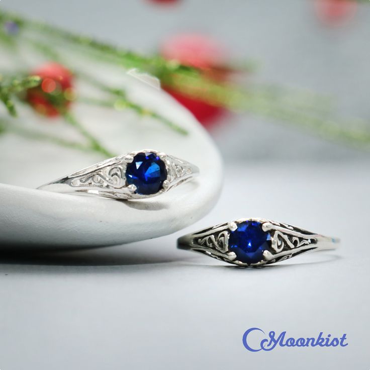 This Unique Victorian-style Sapphire Engagement Ring features a sparkling 5 mm (approximately .5 carat) round gemstone set in a dainty filigree setting. This beautiful ring has a low-profile filigree mounting that protects the stone, but allows enough light in for it to sparkle brightly! This comfortable, snag-free setting is perfect for active people who are busy with their hands. The mounting tapers gracefully from 6 mm at the widest point to 1.5 mm at the band. The band has been smoothed and Gift Sapphire Ring With Brilliant Cut Cubic Zirconia, Gift Sapphire Rings With Brilliant Cut, Classic Sapphire Birthstone Ring Gift, Sapphire Solitaire Jewelry For Anniversary, Sapphire Solitaire Promise Jewelry, Sapphire Birthstone Ring With Brilliant Cut For Gift, Silver Sapphire Ring With Round Stone For Gift, Gift Sapphire Birthstone Ring With Brilliant Cut, Anniversary Sapphire Solitaire Jewelry