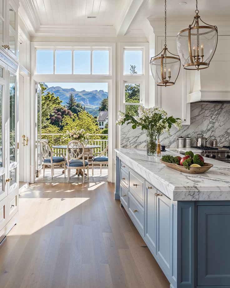 a large kitchen with blue cabinets and marble counter tops, along with an open floor plan