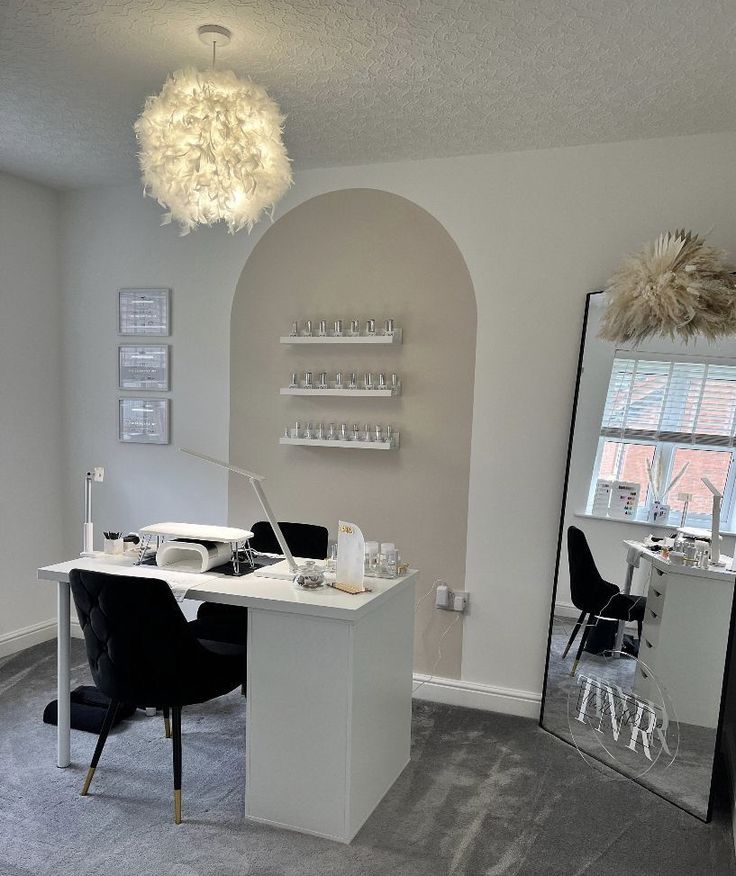 a room with a mirror, table and chairs in it next to a wall mounted shelf