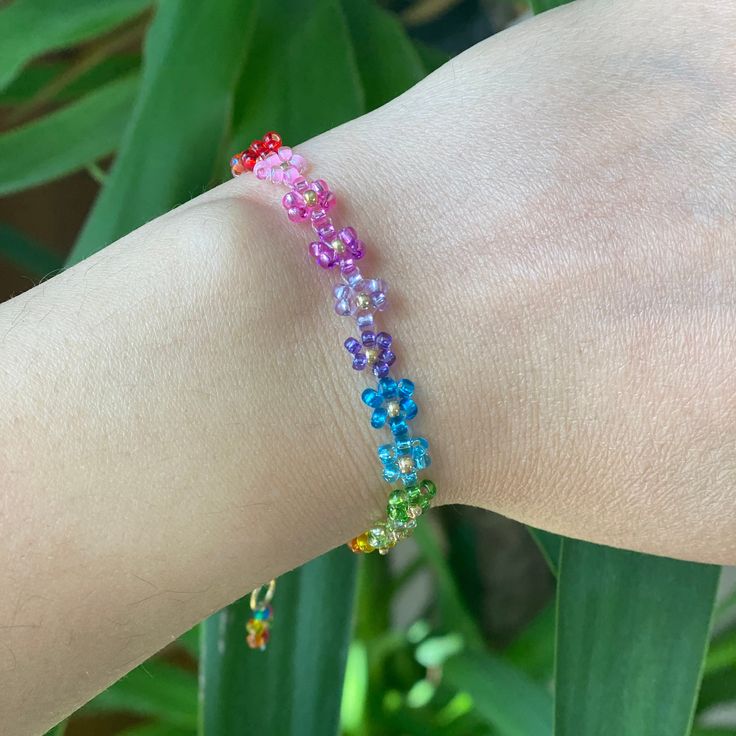 Rainbow coloured bead bracelet with a delicate design. The Floral Daisy Bracelet will brighten up your look. A beaded bracelet crafted by hand with high-quality beads. Galvanized gold beads and shiny beads are used to embellish it. Thank you very much for visiting our shop. We hope you have a great shopping experience! If you are struggling to find the information you need, please feel free to contact us. Do not forget to take a look at our other products in our shop. 😊 ➡️ Matching necklace: ⬇️ Colorful Beaded Bracelets For Spring, Colorful Beads Friendship Bracelets For Spring Gift, Colorful Beads Friendship Bracelet For Spring Gift, Spring Friendship Bracelets With Colorful Beads As Gift, Multicolor Beaded Bracelets For Spring, Spring Multicolor Beaded Bracelets With Round Beads, Spring Gift Friendship Bracelets With Colorful Beads, Rainbow Tiny Beads Bracelet, Multicolor Flower Spacer Beads Jewelry