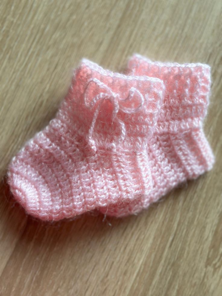 Newborn socks Knit baby socks Cozy baby booties Woolen baby shoes Infant baby shoes Give tenderness to your newborn with our unique hand-crocheted socks. These socks are not only warm and soft but also possess the charming essence of handmade craftsmanship. The perfect addition to your baby's first days in the world! Our socks are available in various colors and patterns, making them an excellent gift for new parents. Gift your little one with tenderness and comfort through our unique, love-craf Crochet Preemie Baby Shoes, Baby Socks Wool, Knit Baby Shoes Free Pattern Newborns, Baby Socks Free Pattern Crochet, Crochet Newboenbaby Socks Free Pattern, Baby Socks Flowers Tutorial, Knitting Baby Shoes Tutorial, Free Crochet Patterns For Baby Socks, Baby Sock Patterns