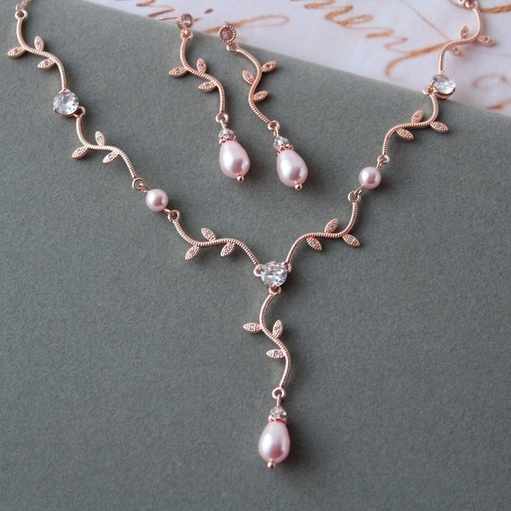 Wedding  jewelry set  Prom jewellery Colour: rose gold(copper tone)/clear/rosaline pink pearls NOTE:Some details can be little bit different as in stock at this moment. Measurements: *earrings approx 5.5 cm *necklace approx: length 18 inches (+1.5 inches extender chain) Materials:  rose gold plated  over brass components, clear zircon crystals, Swarovski rosaline pink faux pearls. Stud earrings. Great for wedding or other celebration. MORE JEWELRY: https://www.etsy.com/uk/shop/BridalArtDeco?ref=seller-platform-mcnav&search_query=jewelry MATCHING HAIR ACCESSORIES: https://www.etsy.com/uk/shop/BridalArtDeco?ref=seller-platform-mcnav&search_query=hair Please note some images have been enlarged to allow for details to be shown. Read the descriptions for details on actual size of each item. In Pearl Drop Earrings Wedding, Pink Pearl Jewelry, Pearl Wedding Jewelry Sets, Drop Earrings Wedding, Rose Gold Wedding Jewelry, Pearl Jewelry Gift, Wedding Jewelry Set, Wedding Earrings Drop, Bridal Jewelry Set