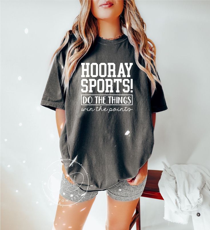 Hooray Sports Shirt AT CHECKOUT: ▪️ Shirt Color(Shown in Pepper) ▪️ Size ▪️ Design Color SHIRT INFO: ▪️ Comfort Color heavy blend shirts ▪️ All shirts are unisex fit. Please refer to the size chart provided in the listing photos for more details. ▪️ For oversized look please size UP 1-2 sizes ▪️ Unisex, 6.1 oz, 100% ring spun cotton, garment-dyed, DESIGN INFO: ▪️ Design is heat transfer vinyl and is applied to each shirt with a commercial grade heat press. ▪️ There may at times be a slight diffe Go Sports Shirt, Game Day Moisture-wicking Sports Fan Tops, Sports Fan Moisture-wicking Tops For Game Day, Moisture-wicking Tops For Game Day, Sports Fan Style, Sporty Athletic Heather T-shirt For Sports, Sporty Team Name T-shirt For Workout, Sporty T-shirt With Team Name For Gym, School Spirit Sports Shirt With Crew Neck, Sporty Moisture-wicking Activewear For Game Day