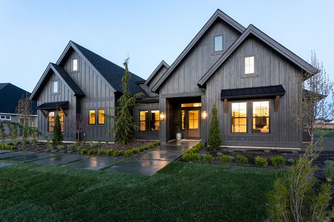 a large house with lots of windows and grass