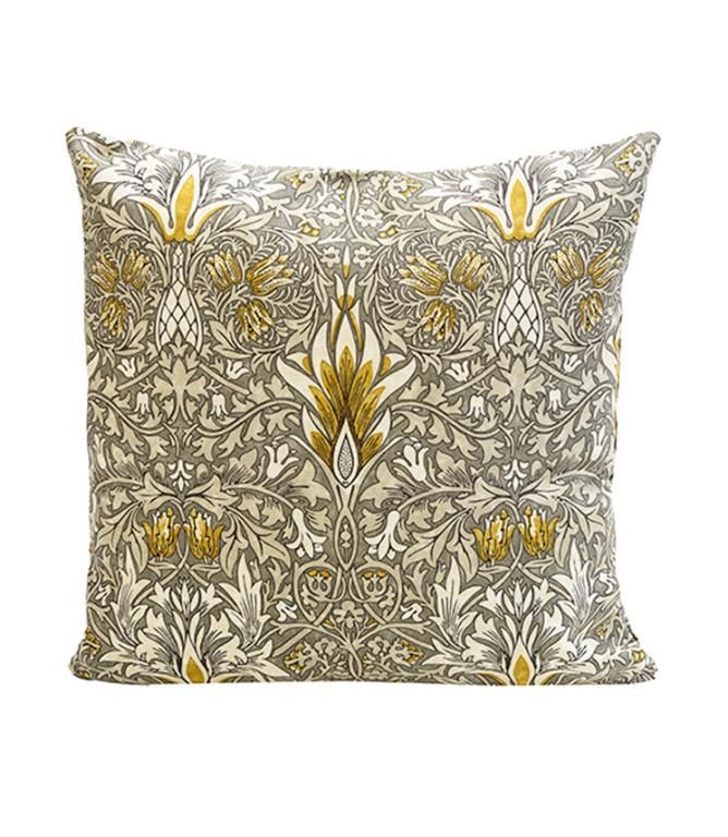 an intricately designed pillow with gold accents