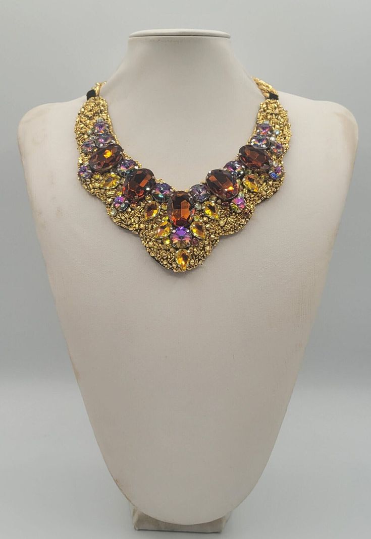 Each piece of our statement necklaces is handmade and one of a kind made in Italy. Our creations is made of high quality materials such as crystals and rhinestones. Each embroidered material is carefully hand sewn. Very glamorous and stylish. Perfect gift to someone you like. Materials Strass stone and Rhinestone in Rainbow, Cooper and Brown color in different dimension.  Black satin fabric backing. Aluminium chain with lobster closure. Measurements Weight approximate 200 grams. Chain lenght 25 cm - 9.84 in Circumference approximate 63 cm - 24.80 in Feel free to contact us if you have any question. Thank you so much for looking at our shop and our articles each of them, single piece. Luxury Rhinestone Necklaces For Parties, Luxury Handmade Beaded Necklaces For Formal Occasions, Elegant Multicolor Crystal Necklaces For Party, Handmade Elegant Crystal Rhinestone Necklace, Luxury Evening Necklaces With Stones, Elegant Handmade Crystal Rhinestone Necklace, Elegant Beaded Necklaces With Stones For Party, Elegant Multicolor Crystal Beaded Necklaces, Luxury Stone Necklaces For Evening