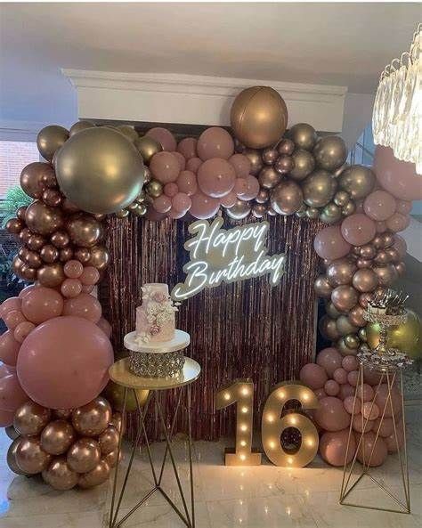 a birthday cake surrounded by balloons and streamers in front of a happy birthday sign