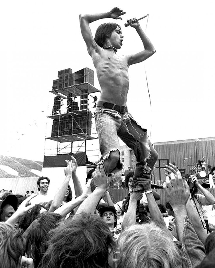 a man standing on top of a crowd of people