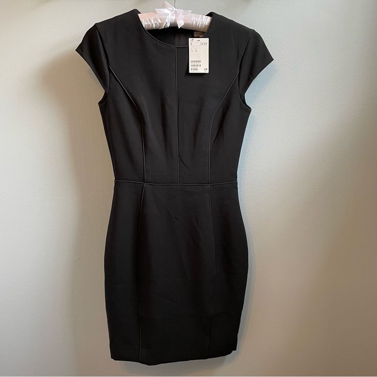 Classic Little Black Sheath Dress By H&M Lined Piping Detail Size 2 French Girl Style Great Addition To A Capsule Wardrobe Cocktail Dress Business Office Attire Lbd Approximately Length 35.5” Waist 12.75” Lined Stretch Mini Dress For Work, Stretch Lined Mini Dress For Work, Fitted Sheath Mini Dress For Work, Black Sheath Bodycon Dress For Work, H&m Knee-length Dress For Date Night, Black Mini Dress With Back Zipper For Work, Black Dresses For Work With Back Zipper, Black Workwear Dress With Back Zipper, Short Sleeve Lined Mini Dress For Work