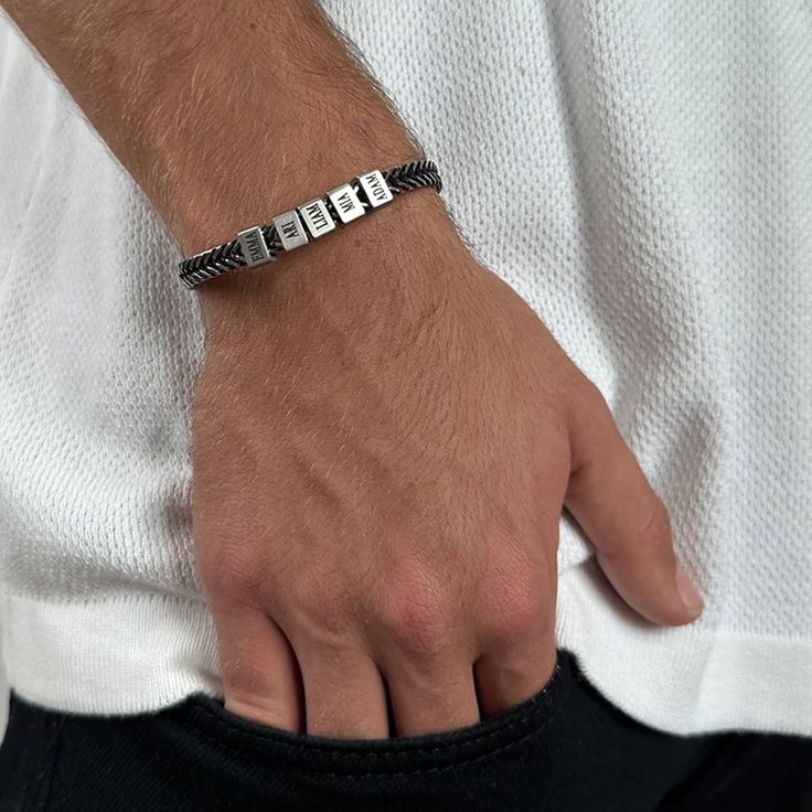 "This simple and beautiful stylish men's stainless steel bracelet comes with with 5 custom stainless steel beads, each with an inscription of its own. The bracelet comes with 5 beads, you can decide which to personalize and the rest will remain empty. ITEM DETAILS: * Waterproof and Sweatproof. * Font color: Black * Bracelet length: 7\" (18cm). * Bracelet comes with a 2\" (5 cm) extension chain. * Please mention your font preference when ordering Every purchase comes packaged in a sweet box. It c Personalized Black Jewelry For Father's Day, Black Jewelry For Father's Day Personalized Gift, Personalized Adjustable Sterling Silver Bracelet, Jubilee Bracelet In Stainless Steel For Friendship, Modern Jewelry For Father's Day Personalized Gift, Adjustable Silver Jubilee Name Bracelet, Adjustable Stainless Steel Chain Bracelet For Friendship, Modern Personalized Jewelry For Friendship, Adjustable Bracelets For Father's Day Gift