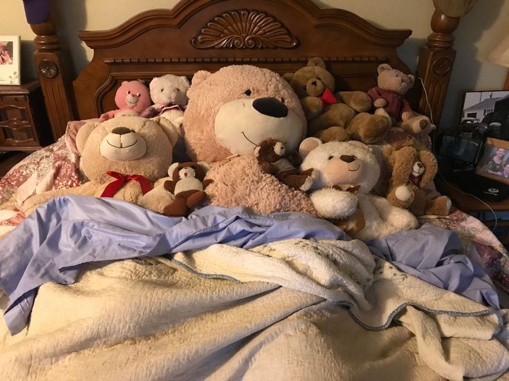 there are many stuffed animals on the bed