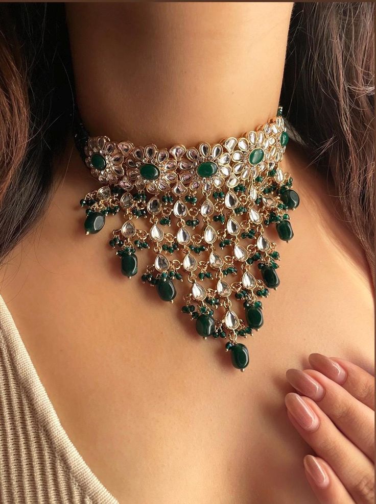 Adorn yourself in timeless elegance with this exquisite green Kundan and zircon necklace set, perfect for weddings and special occasions. Crafted with meticulous attention to detail, the set features delicate green hues reminiscent of Pakistani and Punjabi traditions, with a touch of Bollywood glamour. Complete with matching earrings and a stunning maangtika, this Indian Kundan ensemble effortlessly captures the essence of sophistication and grace. Measurements:   Necklace Length-14" Necklace Wi Traditional Pista Green Jewelry For Wedding, Green Kundan Bridal Necklace Hand Set, Green Bollywood Bridal Sets For Reception, Green Bridal Sets For Diwali Reception, Diwali Reception Green Bridal Sets, Festive Emerald Green Bridal Necklace, Green Kundan Jewelry For Wedding, Bollywood Style Green Kundan Necklace With Stone Work, Green Kundan Necklace For Reception And Festivals