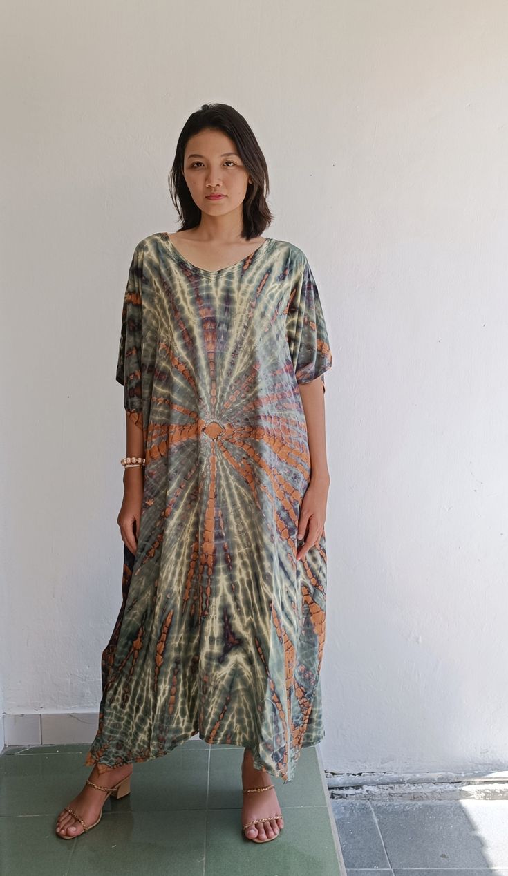 Matahari Kaftan Dress Made with lightweight and breathable rayon, loose and easy fit with an eye catching color blocking, this kaftan perfect for every occasion.  ◇ Color - Tie dye - green and brown ◇ Size One size lenght : 116 cm/ 45.6 inch chest : 166cm/ 65,3 inch US Women size from S To XXL (small to plus size ) ◇ Nagia style model  Her height is 170 cm  Weight is 50 cm  Made from soft rayon Hand cool wash At first, you may smell the unique print and dye. It will disappear after you wash it. Spring Bohemian Kaftan With Batik Print, Spring Bohemian Batik Print Kaftan, Bohemian Batik Print Maxi Dress In Free Size, Multicolor Boho Maxi Dress For Beach Cover-up, Multicolor Boho Maxi Dress For Beach, Oversized Short Sleeve Kaftan For Summer, Bohemian Batik Print Tunic Dress, Casual Rayon Kaftan For Beach, Bohemian Tunic Dress With Batik Print