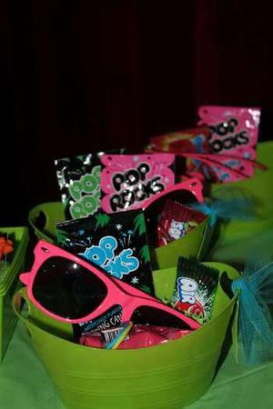 some pink and green bowls with hello kitty sunglasses in them