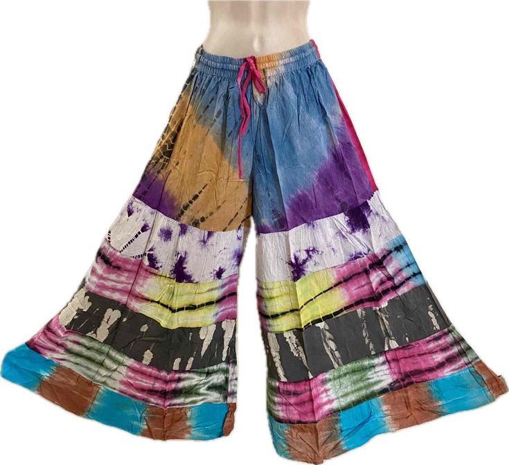 Sacred Threads Hippie Boho Festival No Match Tiered Palazzo Pants 224342 L/XL Sacred Threads Hippie Boho Festival No Match Tiered Palazzo Pants 224342 L/XL Click images to enlarge Description Bohemian Groove Threads One stop shopping for authentic hippie bohemian clothing Artsy clothing for creative people who aren't afraid to show a little color!  100%  Rayon no match tiered palazzo pants with elastic waist and drawstring, NO pockets. The fabric on these pants have a really nice drape and would look beautiful with a flowy bohemian peasant top. The model is just to show what the item looks like on, but the item hanging in the separate picture is the exact  pattern you will receive.  Check the measurements below. Garment Measurements Palazzo Pants Waist = 25-36 Hip = 48 Rise = 12 Inseam = 2 Artsy Clothing, Sacred Threads, Pants With Elastic Waist, Artsy Outfit, Bohemian Clothing, Peasant Top, Boho Festival, Creative People, Hippie Bohemian