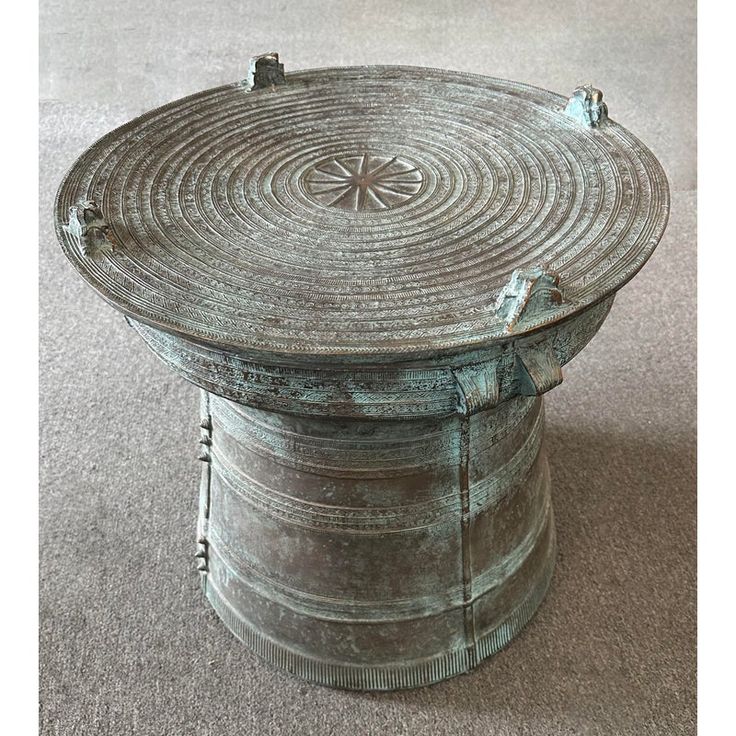 an old round metal container sitting on the floor