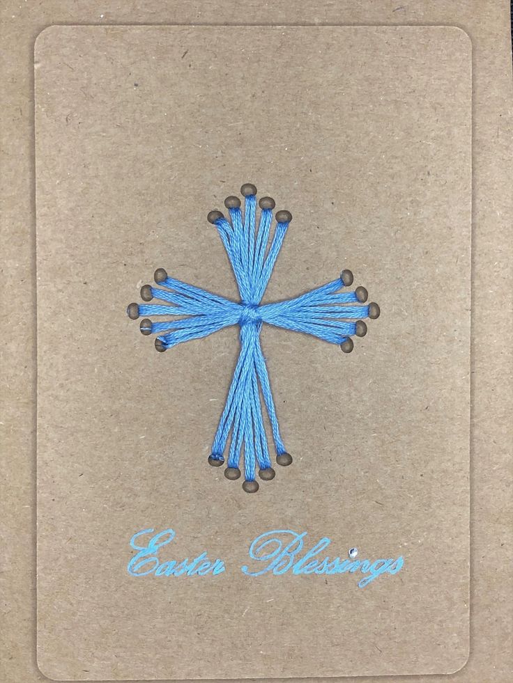 an embroidered blue cross on brown paper with the words easter blessing