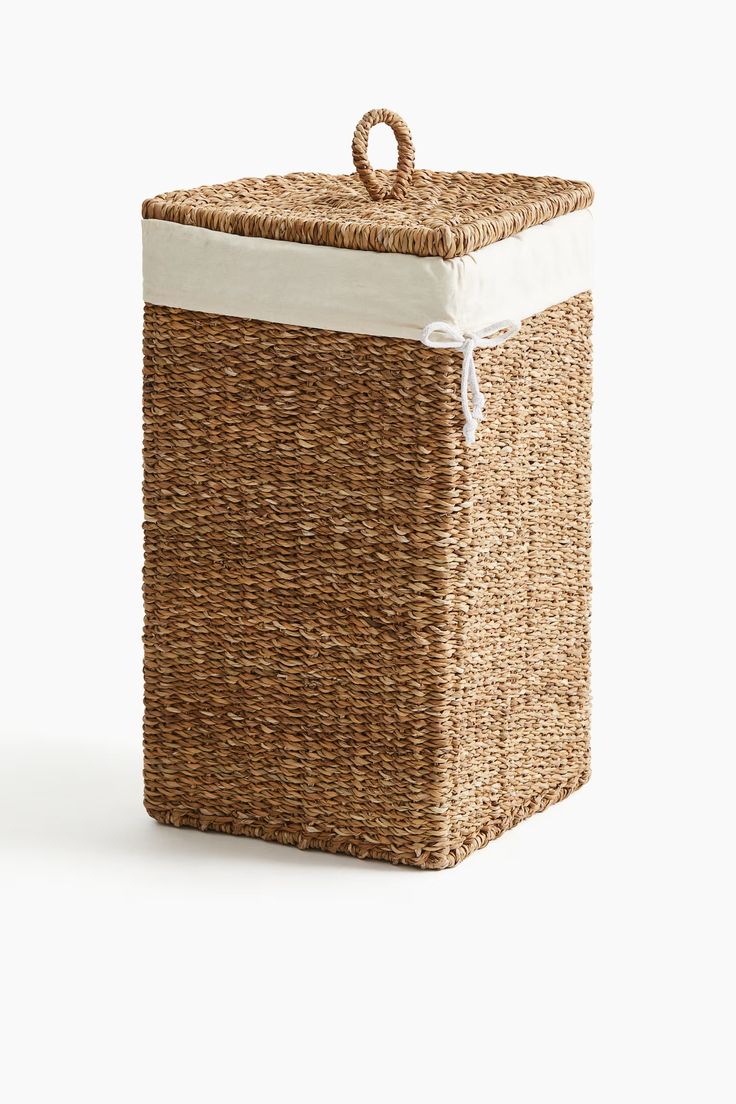 a brown basket with white linings on the sides and a lid that is attached to it