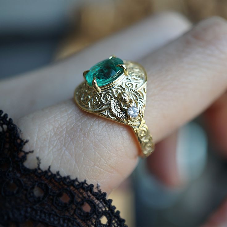 Introducing the "Emerald Scarab Ring" – a captivating blend of ancient Egyptian mystique and timeless elegance. Centered with a lush emerald framed by intricate Islamic patterns inspired by Egypt's architectural wonders, this ring evokes the opulence of ancient Egypt. Flanked by scarabs symbolizing rebirth, each holds a radiant diamond, echoing the sun's eternal sparkle on the Nile's waters. All orders come in our Tippy Taste ring box. This ring is handmade and designed in NYC. 14K or 18K solid Ancient Wedding Rings, Elegant 14k Stamped Emerald Ring, Fine Jewelry Emerald Ring With Intricate Design, Elegant Emerald Ring With Intricate Design, Elegant Yellow Gold Emerald Ring With Intricate Design, Emerald Rings With Intricate Design For Anniversary, Yellow Gold Emerald Ring With Intricate Design, Elegant Gold Emerald Ring, Emerald Ring With Intricate Design