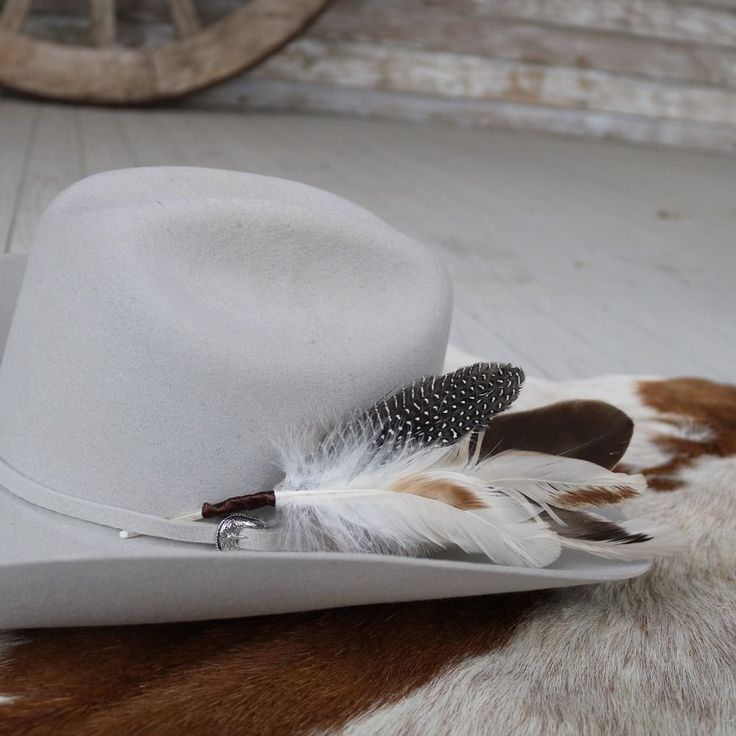 The Cheyenne hat feather is hand constructed with brown and cream feathers for a natural hat accent. Tuck into the band of any hat.Made with a mix of turkey, guinea, and rooster feathers.Approximately 8 inches long, sizes may vary due to being made with natural materials. Natural Feathers Approx. 8 inches - sizes may vary slightly Tuck into the band of any hat! *Hat not included* CA Residents: Prop 65 Warning ↗️ Rodeo Fedora Felt Hat With Feather Trim, Felt Fedora With Feather Trim For Rodeo, Western Fedora With Feathers And Flat Brim, Western Style Fedora With Feathers And Flat Brim, Wide Brim Felt Hat With Feathers For Ranch, Flat Brim Feathered Ranch Hat, Wide Brim Felt Hat With Feathers For Outdoor, Curved Brim Felt Hat With Feathers For Ranch, Western Style Brimmed Fedora With Feathers