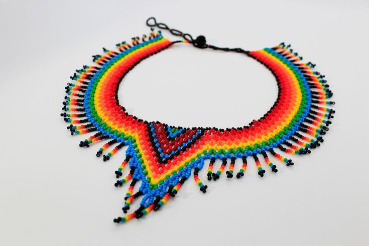 The dimensions of the Necklace: * Length: around the inside of the collar (end to end) is approx. 17.3-21.6 inches (44-55 cm) adjustable * Height: 1.8 inches  (4.5cm)  Max height at the midsection is: 3.15 inches (8cm) * Approximate weight: 42g * Materials: Czech Beads #10/0, cylindrical beads, and high resistance nylon thread. Please contact us if you have any questions. Thank you for looking and have a great day! Bohemian Red Choker For Gift, Bohemian Red Choker Gift, Red Bohemian Choker For Gift, Multicolor Beaded Necklace With Adjustable Length, Adjustable Rainbow Choker Jewelry, Multicolor Beaded Necklace With Adjustable Length As Gift, Multicolor Adjustable Beaded Necklace Gift, Unique Red Choker For Gift, Unique Red Choker As A Gift