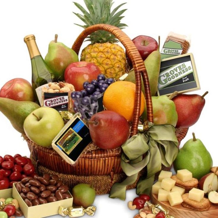 a basket filled with lots of different types of fruit and cheeses next to nuts