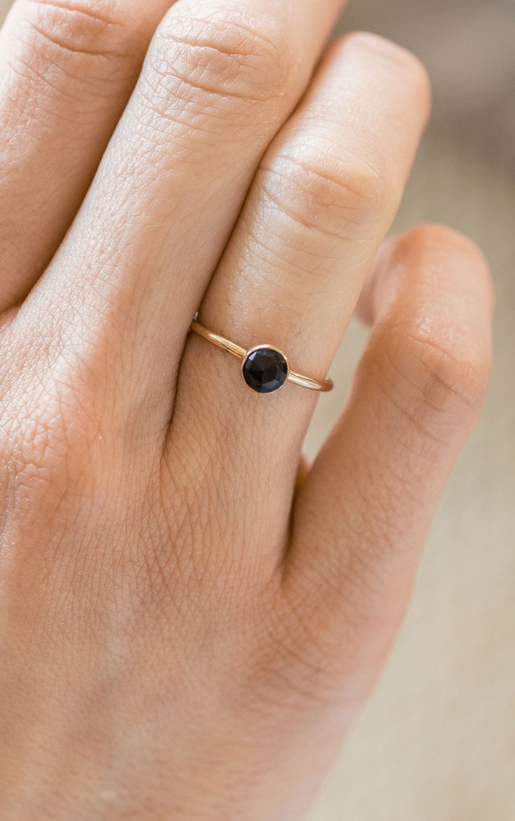 This ring features a round rose cut black onyx stone set in a gold filled bezel. The band is approximately 1.5mm wide, and the stone is 5mm in diameter. Made from 14/20 gold-filled wire, it is water-resistant and will be a piece that lasts. Each piece is custom-made for you, so please allow 1-5 days for the jewelry to ship. - 14/20 Gold Filled - 1.5mm band - 5mm stone - Handmade to order - Comes neatly packaged in a kraft jewelry box ready for gifting Pebble Ring, Black Onyx Jewelry, Dainty Gold Rings, Bezel Set Ring, Gold Gemstone Ring, Ring Birthstone, Onyx Jewelry, Black Onyx Stone, Gold Filled Ring