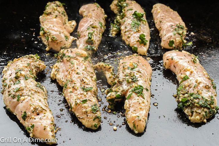 the food is being cooked on the grill in the skillet with some seasoning