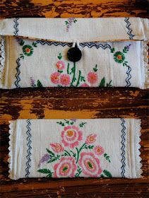 two pieces of cloth with embroidered flowers on them, one has a black button in the middle