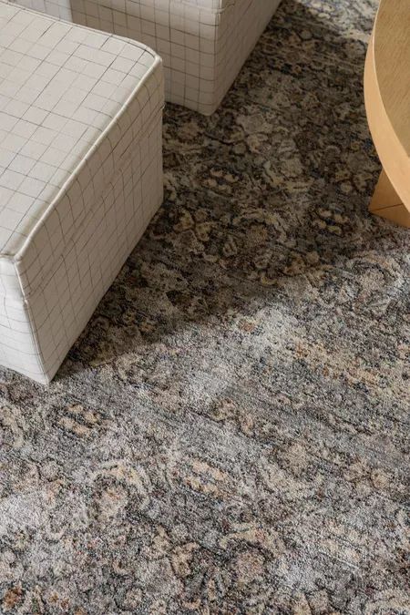 two white chairs sitting next to each other on top of a carpet covered flooring