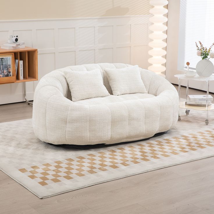 a living room filled with furniture and a white rug