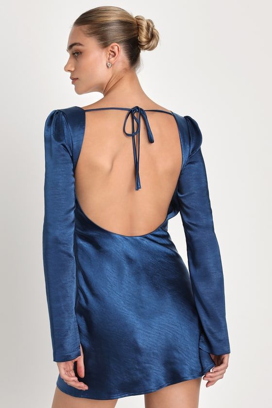 Everyone will want your attention when you're looking so good in the Lulus Adoring Charm Dark Blue Satin Long Sleeve Backless Mini Dress! Sleek woven satin, with a subtle brushed effect throughout, shapes long sleeves with split cuffs and striking gathered shoulders. Bodice has a cowl neckline and a stunning open back, crossed by a single tie. Figure-skimming silhouette continues down to a flaring skirt, finishing at a mini hem. Hidden zipper at side. Fit: This garment fits true to size. Length: Flirty Fitted Backless Dress With Low Back, Fitted Flirty Backless Dress With Low Back, Fitted Backless Dress With Low Back, Fitted Blue Backless Dress For Night Out, Blue Backless Dress For Night Out, Blue Fitted Low Back Dress, Blue Fitted Dress With Low Back, Flirty Fitted Backless Dress With Back Opening, Fitted Flirty Backless Dress With Back Opening