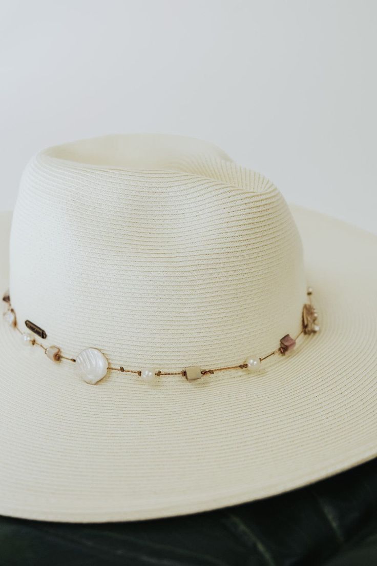 Beige Seashell/Pearl Beach Hat 4" floppy brim pinched front crown attached seashell/pearl/mother of pearl band adjustable inner band Elegant Adjustable Hat Band For Vacation, Elegant Adjustable Panama Hat For Vacation, Cream Fedora For Beach, One Size Fits Most, Elegant Beach Hat, Elegant Adjustable Fedora For Vacation, Elegant Adjustable Hats For Vacation, Adjustable Elegant Panama Hat For Beach, Adjustable Elegant Panama Hat For The Beach, Elegant Cream Fedora For Vacation