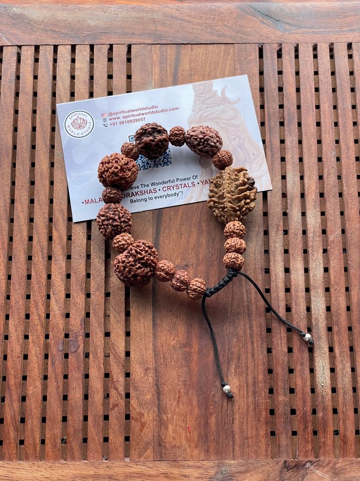 This is a divine bracelet made from natural auspicious beads of 2 - 7 mukhi Rudraksha in black adjustable chord.  This bracelet is adjustable so can fit any wrist size.  This is a healing Shiva bracelet, blessed by priest. The benefits of  2 Mukhi Rudraksha signifies the unity of SHIVA and SHAKTI    We wish you happy wearing and chanting Spiritual Festival Bracelet With 108 Beads, Spiritual Festival Bracelets With 108 Beads, Spiritual Hand-strung Beaded Bracelets For Rituals, Spiritual Beaded Bracelets For Festivals, Spiritual Brown Beaded Bracelets For Rituals, Traditional Bracelets With 8mm Beads For Festivals, Adjustable Spiritual Mala For Puja, Traditional 8mm Beaded Bracelets For Festivals, Adjustable Bracelets For Meditation And Festivals