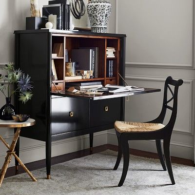 a desk with a chair and bookshelf next to it