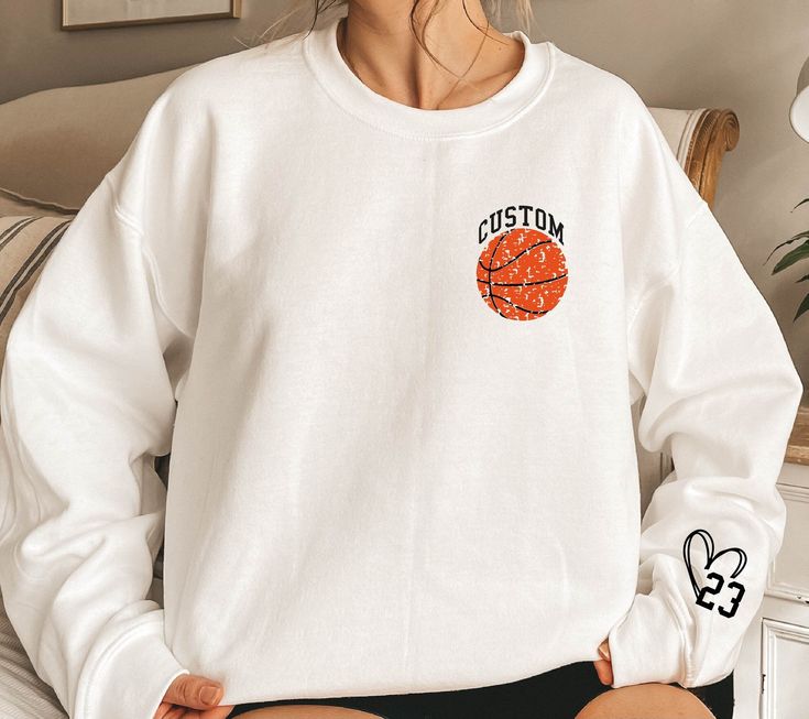 Personalized Basketball Sweatshirt,Your Name Basketball Sweater,Basketball Family Sweater,Custom Number On Sleeve,Custom Basketball Hoodie WELCOME TO "DandelionDesignUShop" ! High quality and super soft, comfortable shirt. Made with top of the line vinyl and pressed with a professional grade heat press. All our simple color ones like White, Black, and Red are 100% Cotton. All our Heathered Colors are cotton/polyester blend and they are super comfy soft!   SIZING AND COLORS Make sure you check ou White Winter Sweatshirt For Sports Events, White Team Logo Hoodie For Game Day, White Hoodie With Team Logo For Streetwear, Collegiate White Hoodie For Sports Season, White Collegiate Hoodie For Sports, Collegiate White Sweatshirt For College, Sporty White Sweatshirt For Game Day, White Sporty Sweatshirt For Game Day, Team-colored Sportswear Sweatshirt For Game Day